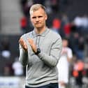 Dons boss Liam Manning had been linked to a move to QPR this summer, but interest appears to be cooling 