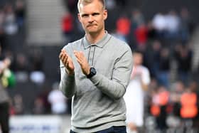 Dons boss Liam Manning had been linked to a move to QPR this summer, but interest appears to be cooling 
