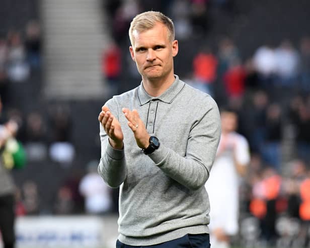 Dons boss Liam Manning had been linked to a move to QPR this summer, but interest appears to be cooling 