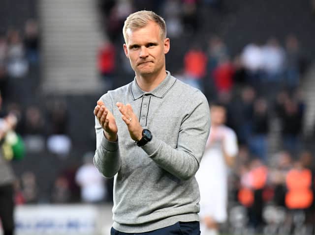<p>Dons boss Liam Manning had been linked to a move to QPR this summer, but interest appears to be cooling </p>