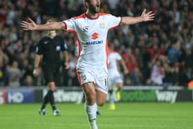 Will Grigg celebrates scoring the first of two goals in the 4-0 win over Manchester United in August 2014