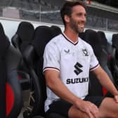 Will Grigg looks over the familiar sight of Stadium MK after signing for the club at long last