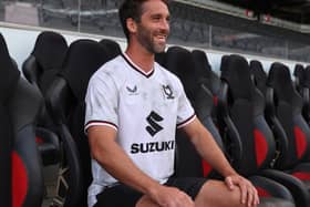 Will Grigg looks over the familiar sight of Stadium MK after signing for the club at long last