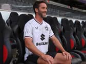 Will Grigg looks over the familiar sight of Stadium MK after signing for the club at long last