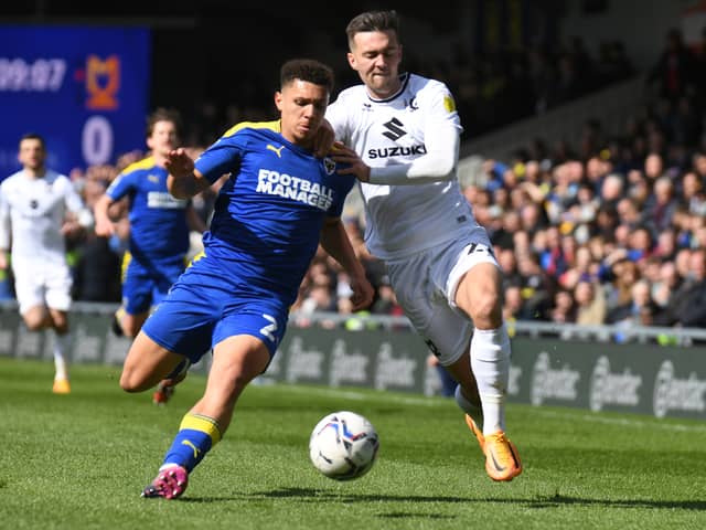 Henry Lawrence battles with Daniel Harvie in the match between AFC Wimbledon and MK Dons at Plough Lane last season. Lawrence joins MK Dons on a season long loan from Chelsea