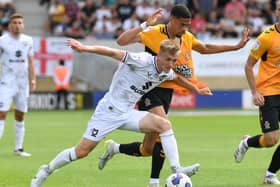 Matt Smith battles for the ball in the 1-0 defeat to Cambridge United. The Welsh midfielder said the first half performance at the Abbey Stadium was a huge disappointment and ultimately cost them