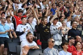 MK Dons supporters cheer their side on against Sheffield Wednesday. The club say they have more season ticket holders  despite price hikes than last year 
