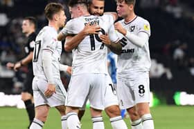 MK Dons celebrate Bradley Johnson’s first goal against Port Vale on Tuesday night