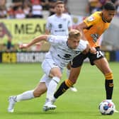 Harvey Knibbs battles with Dons’ Matt Smith during the season opener last month. Knibbs scored the only goal of the game in a 1-0 win for the U's