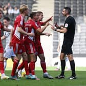 The Accrington player surround referee Tom Reeves during their 1-1 draw with MK Dons on Saturday. Manager John Coleman said the game was there for the taking but his side were not ruthless enough