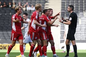 The Accrington player surround referee Tom Reeves during their 1-1 draw with MK Dons on Saturday. Manager John Coleman said the game was there for the taking but his side were not ruthless enough