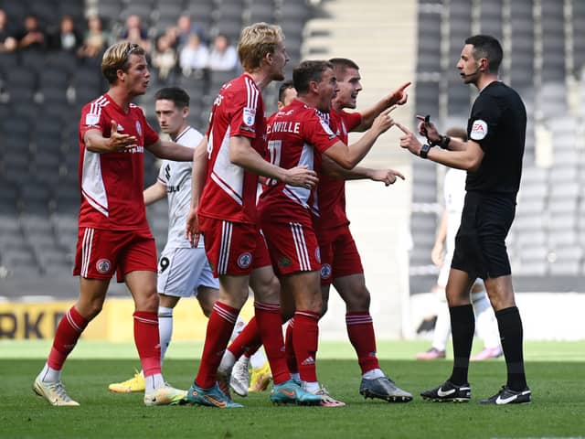 The Accrington player surround referee Tom Reeves during their 1-1 draw with MK Dons on Saturday. Manager John Coleman said the game was there for the taking but his side were not ruthless enough