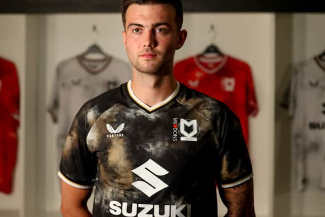 Daniel Harvie models the new MK Dons third strip, but so far it has split opinion amongst the supporters