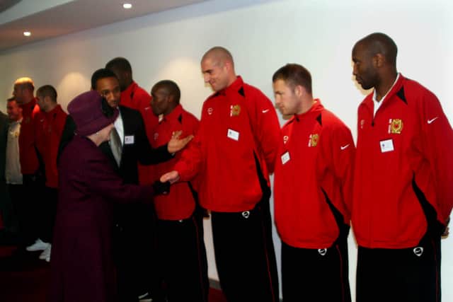 The Queen with then Dons boss Paul Ince, meeting Danny Swailes, Alan Navarro and Drissa Diallo