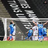Gethin Jones wheels off in celebration after heading in Bolton’s second of the night at Stadium MK to secure their first win in Milton Keynes