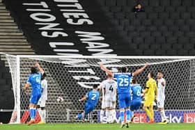 Gethin Jones wheels off in celebration after heading in Bolton’s second of the night at Stadium MK to secure their first win in Milton Keynes
