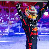 Sergio Perez celebrates atop his Red Bull Racing car after winning a gruelling Singapore Grand Prix on Sunday. Team-mate Max Verstappen was made to wait to win his second world championship