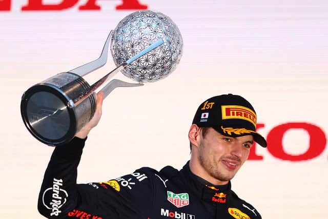 Max Verstappen with the winner’s trophy of the Japanese Grand Prix. The win secured the Dutchman’s second F1 title