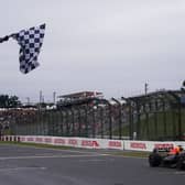 Max Verstappen crosses the line to win the Japanese Grand Prix and claim his second world championship