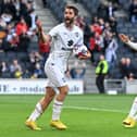 Will Grigg tries to lift the crowd after scoring Dons’ goal on Saturday in the 4-1 defeat to Plymouth Argyle