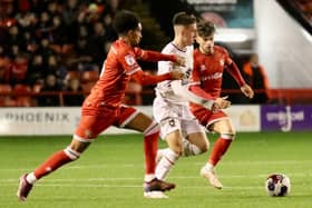 Darragh Burns takes on two Walsall players in the Papa John’s Trophy win on Tuesday night (Pic: Andy Gardner)
