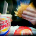  A man eats his lunch at a Burger King restaurant.