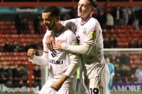Nathan Holland celebrates with Louie Barry after scoring his first goal for MK Dons on Tuesday against Walsall. Pic: Andy Gardner
