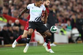 Nathaniel Mendez-Laing of Derby County battles for possession with Nathaniel Phillips of Liverpool during the Carabao Cup Third Round match between Liverpool and Derby County at Anfield