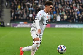 Henry Lawrence in action for MK Dons during the defeat to Derby County