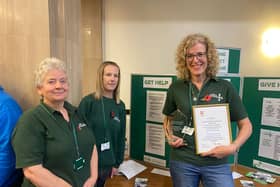 Lindsey Stockton (far right, holding framed document) with food bank colleagues