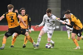 Conor Grant holds off three Newport players during MK Dons’ win in the Papa John’s Trophy on Tuesday night