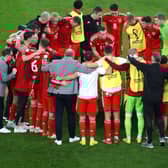 Matt Smith with the Wales squad during a team huddle in Qatar