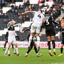 Burton’s Cameron Borthwick-Jackson battles in the air with MK Dons’ Jack Tucker during the 1-1 draw at Stadium MK