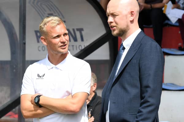 Liam Manning in discussion with Liam Sweeting on the opening day of this season away at Cambridge United. 