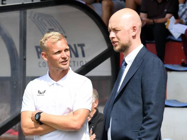 Liam Manning in discussion with Liam Sweeting on the opening day of this season away at Cambridge United. 