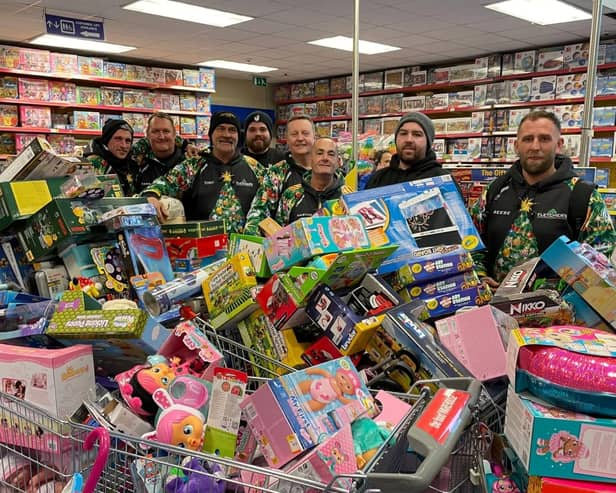 Reese, far right, and his team with some of hundreds of toys they bough from Smyth's Toy Shop