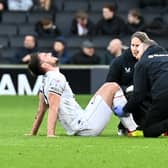 Warren O’Hora suffered injury in the 0-0 draw with Lincoln City on Saturday, and left Stadium MK in a protective boot. He was one of three injury substitutions Dons were forced to make 