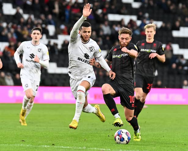 Nathan Holland battles with Lincoln’s Teddy Bishop during the 0-0 draw at Stadium MK