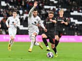 Nathan Holland battles with Lincoln’s Teddy Bishop during the 0-0 draw at Stadium MK