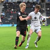 Ethan Robson battles with another former Dons loanee Lasse Sorensen on Saturday against Lincoln City