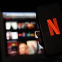 In this photo illustration a computer and a mobile phone screens display the Netflix logo on March 31, 2020 in Arlington, Virginia. (Photo by Olivier DOULIERY / AFP) (Photo by OLIVIER DOULIERY/AFP via Getty Images)