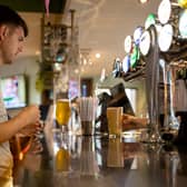 A customer buys a drink at a Wetherspoons pub in Clapham, London.