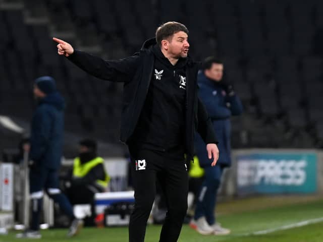Mark Jackson during the 2-0 defeat to Exeter City. The MK Dons head coach has urged his side to tighten up in both penalty areas and to be more ruthless.
