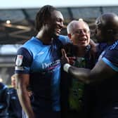 Anthony Stewart and Adebyo Akinfenwa celebrate with Wycombe chairman Rob Couhig