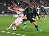 Matt Smith battles Bristol Rovers’ Luke McCormick in the game between the sides at Stadium MK