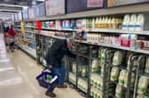 A customer shops for milk inside a Sainsbury's supermarket in east London on February 20, 2023.