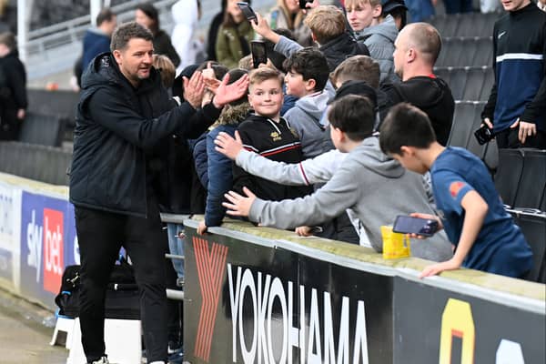 Mark Jackson met with young MK Dons fans around the perimeter of Stadium MK after the win over Morecambe