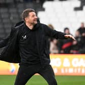 Mark Jackson celebrated with the MK Dons supporters at full-time as his side claimed their third win in a row