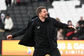 Mark Jackson celebrated with the MK Dons supporters at full-time as his side claimed their third win in a row