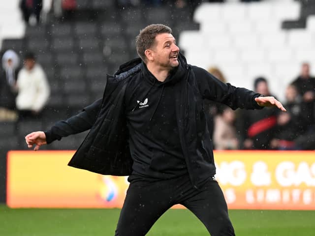Mark Jackson celebrated with the MK Dons supporters at full-time as his side claimed their third win in a row